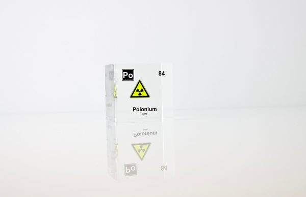 Clear acrylic cube displaying a Polonium element (Atomic Number 84) embedded within, offering a scientific presentation for collectors and science enthusiasts.