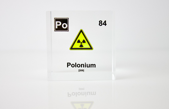 Clear acrylic cube displaying a Polonium element (Atomic Number 84) embedded within, offering a scientific presentation for collectors and science enthusiasts.