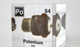 Clear acrylic cube displaying a Polonium element (Atomic Number 84) embedded within, offering a scientific presentation for collectors and science enthusiasts.