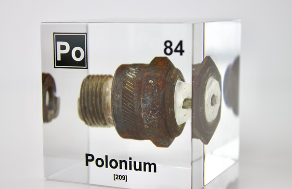 Clear acrylic cube displaying a Polonium element (Atomic Number 84) embedded within, offering a scientific presentation for collectors and science enthusiasts.