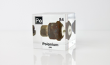 Clear acrylic cube displaying a Polonium element (Atomic Number 84) embedded within, offering a scientific presentation for collectors and science enthusiasts.