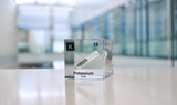 Clear acrylic cube displaying a Potassium element (Atomic Number 19) embedded within, offering a scientific presentation for collectors and science enthusiasts.