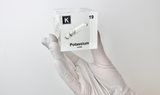 Clear acrylic cube displaying a Potassium element (Atomic Number 19) embedded within, offering a scientific presentation for collectors and science enthusiasts.