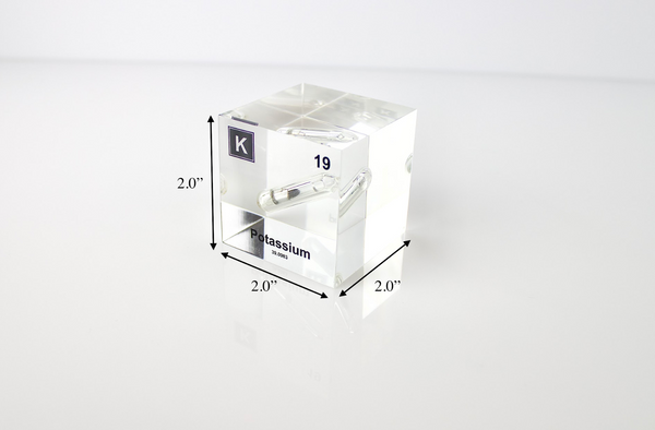 Clear acrylic cube displaying a Potassium element (Atomic Number 19) embedded within, offering a scientific presentation for collectors and science enthusiasts.