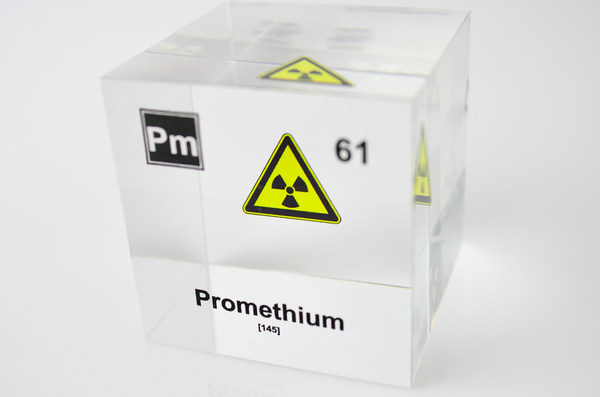 Clear acrylic cube displaying a Promethium element (Atomic Number 61) embedded within, offering a scientific presentation for collectors and science enthusiasts.