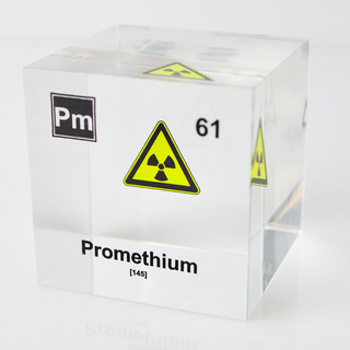 Clear acrylic cube displaying a Promethium element (Atomic Number 61) embedded within, offering a scientific presentation for collectors and science enthusiasts.