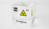 Clear acrylic cube displaying a Promethium element (Atomic Number 61) embedded within, offering a scientific presentation for collectors and science enthusiasts.