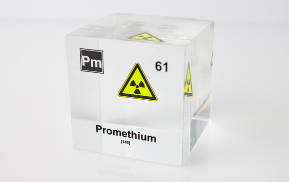 Clear acrylic cube displaying a Promethium element (Atomic Number 61) embedded within, offering a scientific presentation for collectors and science enthusiasts.