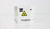 Clear acrylic cube displaying a Promethium element (Atomic Number 61) embedded within, offering a scientific presentation for collectors and science enthusiasts.
