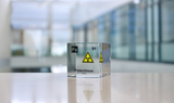 Clear acrylic cube displaying a Protactinium element (Atomic Number 91) embedded within, offering a scientific presentation for collectors and science enthusiasts.