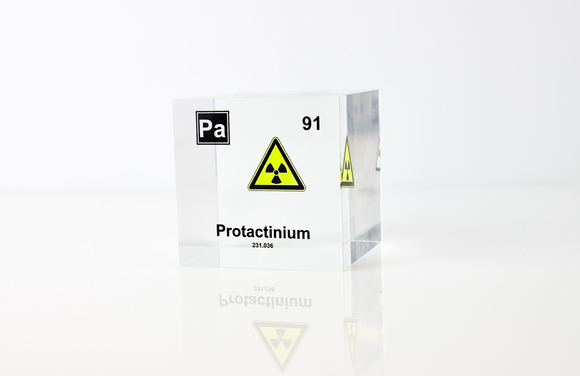 Clear acrylic cube displaying a Protactinium element (Atomic Number 91) embedded within, offering a scientific presentation for collectors and science enthusiasts.