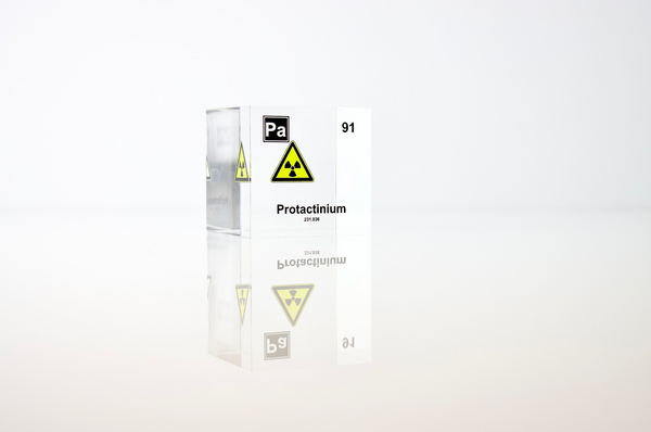 Clear acrylic cube displaying a Protactinium element (Atomic Number 91) embedded within, offering a scientific presentation for collectors and science enthusiasts.