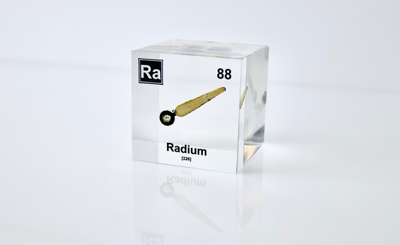 Clear acrylic cube displaying a Radium element (Atomic Number 88) embedded within, offering a scientific presentation for collectors and science enthusiasts.