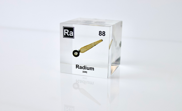 Clear acrylic cube displaying a Radium element (Atomic Number 88) embedded within, offering a scientific presentation for collectors and science enthusiasts.