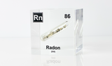 Clear acrylic cube displaying a Radon element (Atomic Number 86) embedded within, offering a scientific presentation for collectors and science enthusiasts.