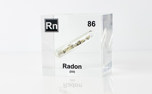 Clear acrylic cube displaying a Radon element (Atomic Number 86) embedded within, offering a scientific presentation for collectors and science enthusiasts.