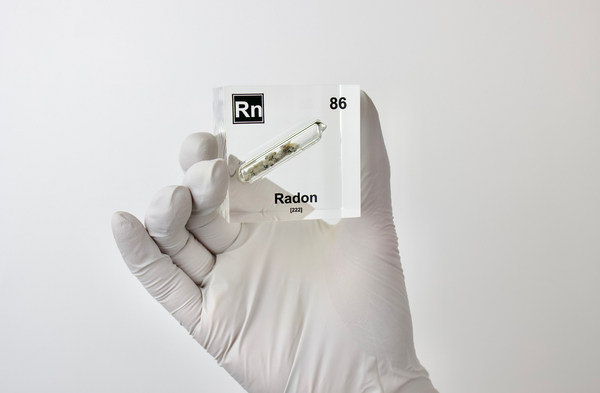 Clear acrylic cube displaying a Radon element (Atomic Number 86) embedded within, offering a scientific presentation for collectors and science enthusiasts.