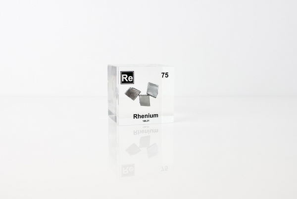 Rhenium element in a clear acrylic cube, featuring its name, atomic number, and properties as shown on the periodic table. A sleek and educational display for collectors and enthusiasts.