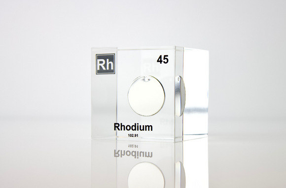 Clear acrylic cube displaying a Rhodium element (Atomic Number 45) embedded within, offering a scientific presentation for collectors and science enthusiasts.