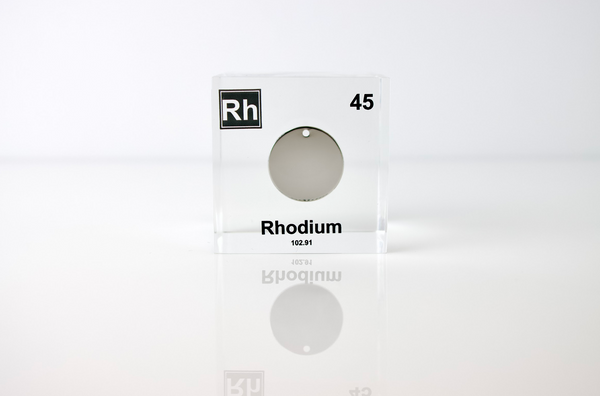 Clear acrylic cube displaying a Rhodium element (Atomic Number 45) embedded within, offering a scientific presentation for collectors and science enthusiasts.