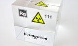 Clear acrylic cube displaying a Roentgenium element (Atomic Number 111) embedded within, offering a scientific presentation for collectors and science enthusiasts.