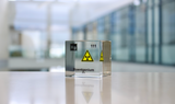 Clear acrylic cube displaying a Roentgenium element (Atomic Number 111) embedded within, offering a scientific presentation for collectors and science enthusiasts.