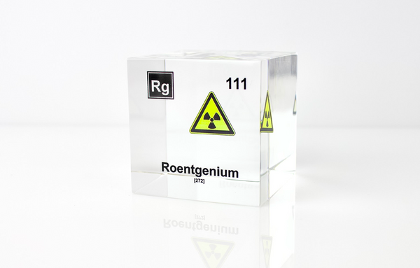 Clear acrylic cube displaying a Roentgenium element (Atomic Number 111) embedded within, offering a scientific presentation for collectors and science enthusiasts.