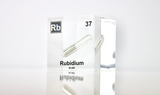 Clear acrylic cube displaying a Rubidium element (Atomic Number 37) embedded within, offering a scientific presentation for collectors and science enthusiasts.