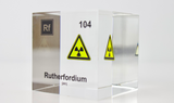 Clear acrylic cube displaying a Rutherfordium element (Atomic Number 104) embedded within, offering a scientific presentation for collectors and science enthusiasts.