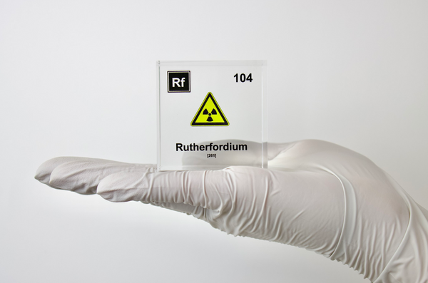 Clear acrylic cube displaying a Rutherfordium element (Atomic Number 104) embedded within, offering a scientific presentation for collectors and science enthusiasts.