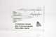 Close-up piece of SR-71 Blackbird titanium embedded in clear acrylic. The fragment is metallic and jagged, which highlights its history from the high-speed reconnaissance aircraft. A blueprint of the SR-71 aircraft is visible in the display.