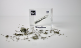Clear acrylic cube displaying a Scandium element (Atomic Number 21) embedded within, offering a scientific presentation for collectors and science enthusiasts.