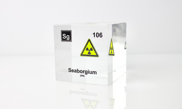 Clear acrylic cube displaying a Seaborgium element (Atomic Number 106) embedded within, offering a scientific presentation for collectors and science enthusiasts.