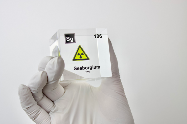 Clear acrylic cube displaying a Seaborgium element (Atomic Number 106) embedded within, offering a scientific presentation for collectors and science enthusiasts.