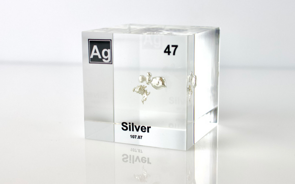 Clear acrylic cube displaying a Silver element (Atomic Number 47) embedded within, offering a scientific presentation for collectors and science enthusiasts.