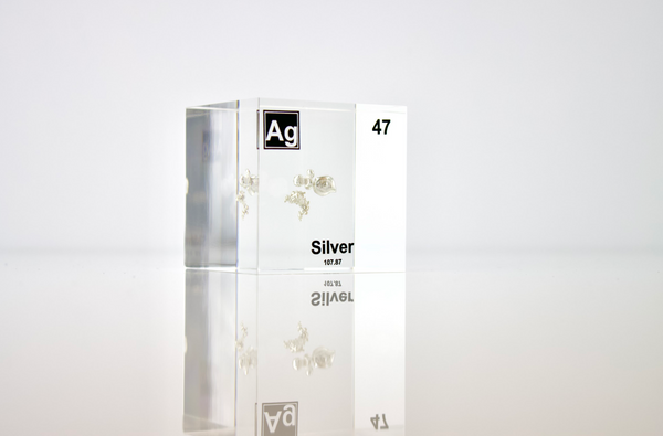 Clear acrylic cube displaying a Silver element (Atomic Number 47) embedded within, offering a scientific presentation for collectors and science enthusiasts.