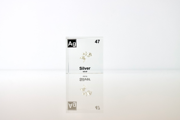 Clear acrylic cube displaying a Silver element (Atomic Number 47) embedded within, offering a scientific presentation for collectors and science enthusiasts.