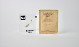 Clear acrylic cube containing a Sodium ampule, marked with its atomic number 11. Perfect for showcasing in educational environments, scientific collections, or as a unique decorative element.
