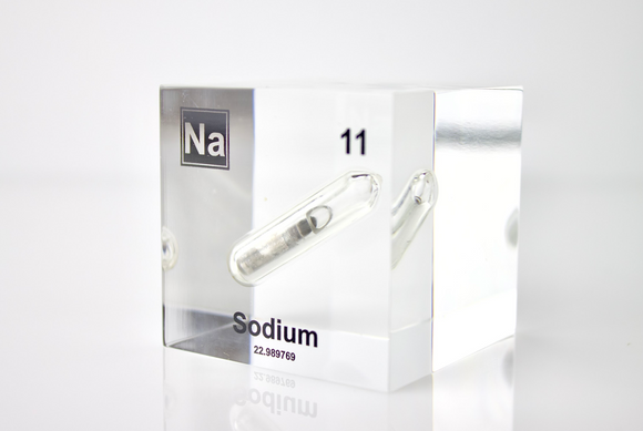 Clear acrylic cube containing a Sodium ampule, marked with its atomic number 11. Perfect for showcasing in educational environments, scientific collections, or as a unique decorative element.