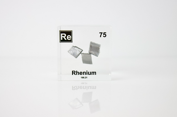 Rhenium element in a clear acrylic cube, featuring its name, atomic number, and properties as shown on the periodic table. A sleek and educational display for collectors and enthusiasts.