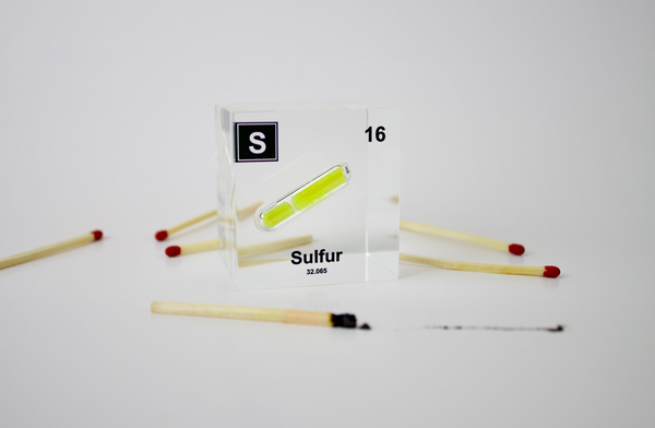 Clear acrylic cube displaying a Sulfur element (Atomic Number 16) embedded within, offering a scientific presentation for collectors and science enthusiasts.