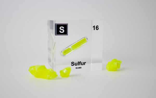 Clear acrylic cube displaying a Sulfur element (Atomic Number 16) embedded within, offering a scientific presentation for collectors and science enthusiasts.