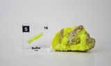 Clear acrylic cube displaying a Sulfur element (Atomic Number 16) embedded within, offering a scientific presentation for collectors and science enthusiasts.