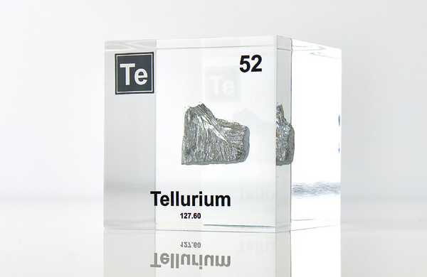 Clear acrylic cube displaying a Tellurium element (Atomic Number 52) embedded within, offering a scientific presentation for collectors and science enthusiasts.