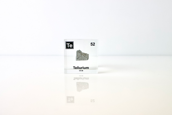 Clear acrylic cube displaying a Tellurium element (Atomic Number 52) embedded within, offering a scientific presentation for collectors and science enthusiasts.