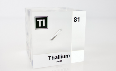 Clear acrylic cube displaying a Thallium element (Atomic Number 81) embedded within, offering a scientific presentation for collectors and science enthusiasts.
