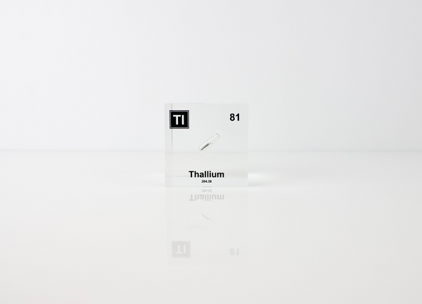 Clear acrylic cube displaying a Thallium element (Atomic Number 81) embedded within, offering a scientific presentation for collectors and science enthusiasts.