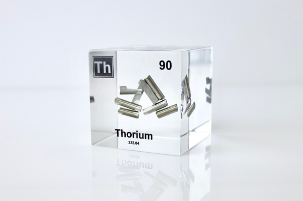 Clear acrylic cube displaying a Thorium element (Atomic Number 90) embedded within, offering a scientific presentation for collectors and science enthusiasts.