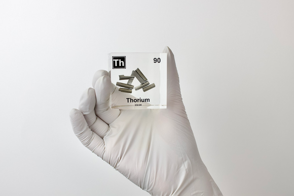 Clear acrylic cube displaying a Thorium element (Atomic Number 90) embedded within, offering a scientific presentation for collectors and science enthusiasts.