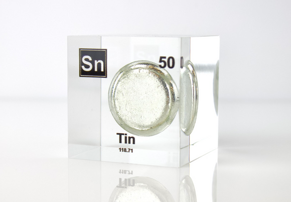 Clear acrylic cube displaying a Tin element (Atomic Number 50) embedded within, offering a scientific presentation for collectors and science enthusiasts.